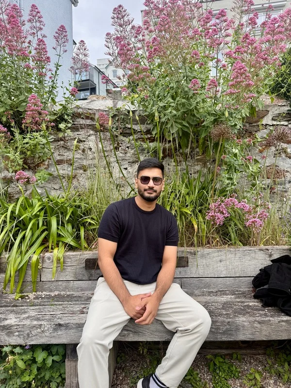 Muhammad Ishaq among pink flowers